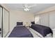 Bright bedroom featuring two beds, ceiling fan, mirrored closet, and tiled floor at 6342 Midnight Pass Rd # 212, Sarasota, FL 34242