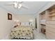 Bright bedroom with overhead fan provides ample storage with built in closet and shelving at 6342 Midnight Pass Rd # 212, Sarasota, FL 34242