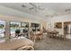 Inviting common room features comfortable seating, tile floors, and a view of the sparkling pool at 6342 Midnight Pass Rd # 212, Sarasota, FL 34242
