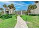 View of the grounds with walkway, lawn, landscaping, and residential buildings at 6342 Midnight Pass Rd # 212, Sarasota, FL 34242