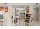 Bright kitchen featuring granite counters, white appliances and cabinets and a breakfast bar with seating at 6342 Midnight Pass Rd # 212, Sarasota, FL 34242