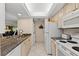 Bright kitchen features granite counters, white appliances and cabinets, and a convenient laundry area at 6342 Midnight Pass Rd # 212, Sarasota, FL 34242