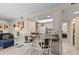Bright kitchen with breakfast bar seating open to the cozy living space with beach-inspired decor at 6342 Midnight Pass Rd # 212, Sarasota, FL 34242