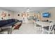 Open concept living area featuring comfortable sofa, TV, and adjacent dining and kitchen spaces at 6342 Midnight Pass Rd # 212, Sarasota, FL 34242
