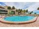 Inviting community pool with clear blue water, surrounded by lounge chairs and lush landscaping at 6342 Midnight Pass Rd # 212, Sarasota, FL 34242