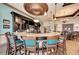 Upscale bar featuring granite countertops, pendant lighting, TV screens, and comfortable seating for residents and guests at 6638 Willowshire Way, Bradenton, FL 34212