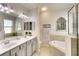 Luxurious bathroom features a double sink vanity, soaking tub, and detailed mirrors that enhance the space at 6638 Willowshire Way, Bradenton, FL 34212