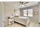 Bright bedroom features a white bed frame, soft lighting, and a large window with a pleasant view at 6638 Willowshire Way, Bradenton, FL 34212