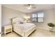 Bright bedroom with a white wood bed frame, ceiling fan, and lots of natural light from the large window at 6638 Willowshire Way, Bradenton, FL 34212