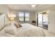 Cozy bedroom with a comfortable bed, view of the water, and access to an outdoor space at 6638 Willowshire Way, Bradenton, FL 34212