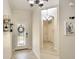 Inviting entryway featuring tile floors, decorative mirror, and a front door with glass detailing at 6638 Willowshire Way, Bradenton, FL 34212