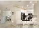 Well-lit kitchen featuring white cabinets, stainless steel appliances, and a breakfast bar at 6638 Willowshire Way, Bradenton, FL 34212