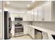 Modern kitchen with white cabinetry, stainless steel appliances, and sleek countertops at 6638 Willowshire Way, Bradenton, FL 34212