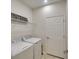 Convenient laundry room with washer, dryer, and shelving for storage of laundry supplies at 6638 Willowshire Way, Bradenton, FL 34212