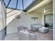 Comfortable screened porch with wicker seating and serene lake views, ideal for relaxation and outdoor living at 6638 Willowshire Way, Bradenton, FL 34212