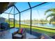 Relaxing screened porch with comfortable seating and serene lake views, perfect for outdoor enjoyment at 6638 Willowshire Way, Bradenton, FL 34212