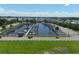 Aerial view of marina with a lot of boat slips, boats, a car, and grassy area in a waterfront community at 6731 Northampton Pl, Bradenton, FL 34207