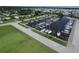 Aerial view of marina with boats docked, surrounded by grass, a fence and landscaping in a waterfront community at 6731 Northampton Pl, Bradenton, FL 34207