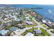 Scenic aerial view of a waterfront community showcasing charming homes, green landscaping, and sparkling water views at 6731 Northampton Pl, Bradenton, FL 34207