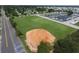 Aerial view of a large field with a baseball field, parking, and boat docks in a waterfront community at 6731 Northampton Pl, Bradenton, FL 34207