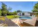 Backyard features a stock tank pool and lush tropical landscaping at 6731 Northampton Pl, Bradenton, FL 34207
