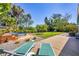 Landscaped backyard features a stock tank pool, patio, lawn, and mature palm trees at 6731 Northampton Pl, Bradenton, FL 34207