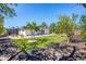 Tropical landscaped backyard features a fire pit, stock tank pool, and patio at 6731 Northampton Pl, Bradenton, FL 34207