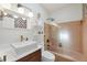 Contemporary bathroom featuring a floating sink with bowl, toilet, and shower-tub combination at 6731 Northampton Pl, Bradenton, FL 34207