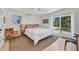 Bright bedroom with slider access to back yard, ceiling fan, and minimalist decor and furnishings at 6731 Northampton Pl, Bradenton, FL 34207