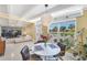 Bright dining area features a round table and a large window with neighborhood views and access to a living area at 6731 Northampton Pl, Bradenton, FL 34207