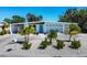 Charming single-story home featuring a modern design, well-kept landscaping, and a inviting blue front door at 6731 Northampton Pl, Bradenton, FL 34207