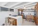 Well-lit modern kitchen with stainless steel appliances, quartz countertops, and breakfast bar seating at 6731 Northampton Pl, Bradenton, FL 34207