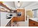Bright kitchen featuring modern wood cabinets, quartz countertops, and stylish open shelving at 6731 Northampton Pl, Bradenton, FL 34207