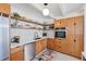 Well-lit kitchen with wooden cabinets, tile backsplash, and modern stainless steel appliances at 6731 Northampton Pl, Bradenton, FL 34207