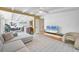 Open-concept living room with a comfortable sectional sofa, modern TV, and bright natural light at 6731 Northampton Pl, Bradenton, FL 34207