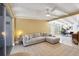 Inviting living room with neutral sectional, ceiling fan, and access to the dining area at 6731 Northampton Pl, Bradenton, FL 34207