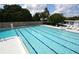 Outdoor pool with swimming lanes, surrounded by white lounge chairs and manicured landscaping at 6731 Northampton Pl, Bradenton, FL 34207