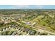 Aerial view of a residential community featuring single-Gathering homes, lakes, and green spaces in a suburban setting at 7012 White Willow Ct, Sarasota, FL 34243