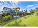 Spacious backyard with a screened-in pool, complemented by vibrant landscaping and lush green lawn at 7012 White Willow Ct, Sarasota, FL 34243