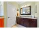 Bathroom featuring a granite-topped vanity and white wooden door at 7012 White Willow Ct, Sarasota, FL 34243