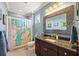 Stylish bathroom with a unique map shower curtain and granite countertop vanity at 7012 White Willow Ct, Sarasota, FL 34243
