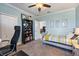 Cozy bedroom with a ceiling fan, soft carpet, and a view into the hallway at 7012 White Willow Ct, Sarasota, FL 34243