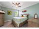 Bedroom featuring tropical decor, a ceiling fan, and natural light from the window at 7012 White Willow Ct, Sarasota, FL 34243