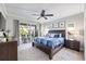 Bright bedroom with a ceiling fan and slider doors to an outdoor patio at 7012 White Willow Ct, Sarasota, FL 34243