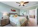 Comfortable bedroom with tropical decor, a bed, and view into another room at 7012 White Willow Ct, Sarasota, FL 34243