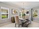 Inviting dining room with a wood table, comfortable seating, natural light, and stylish decor at 7012 White Willow Ct, Sarasota, FL 34243