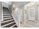 Welcoming entryway featuring a staircase and glass-paneled front door at 7012 White Willow Ct, Sarasota, FL 34243