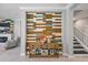 Stylish entryway features a decorative wood accent wall, console table, and open access to the staircase at 7012 White Willow Ct, Sarasota, FL 34243