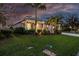 Charming one-story home with well-lit landscaping, lush lawn, and elegant architectural details at 7012 White Willow Ct, Sarasota, FL 34243