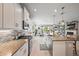 Well-equipped kitchen with white cabinets, granite countertops, and a stylish tile backsplash at 7012 White Willow Ct, Sarasota, FL 34243